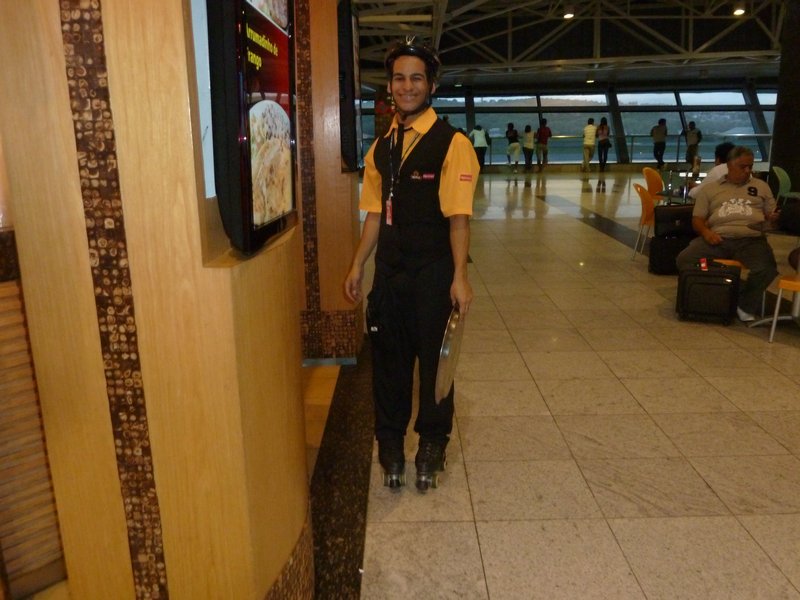 A waiter on rollerskates at the Salvador Airport