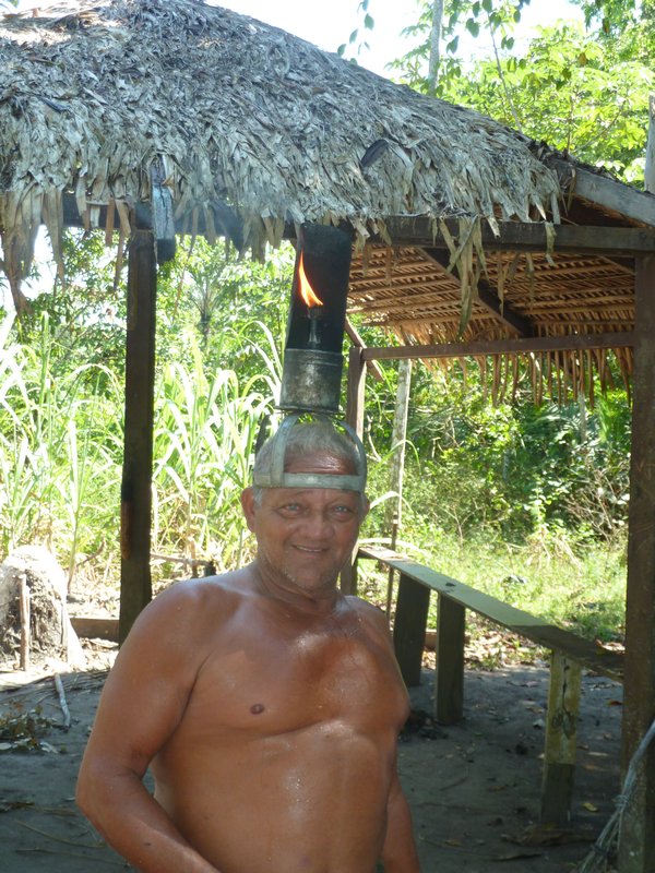 A traditional rubber plantation villager - check out his flame torch