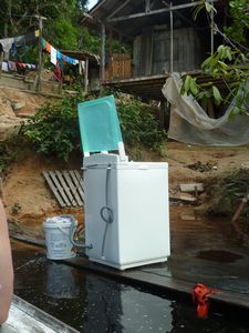 Life along the Amazon River - outside washing machine near water supply - the river