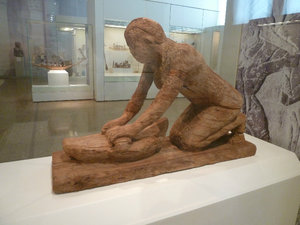 Wooden statue of woman grinding cereal 2416 BC National Archaeological Museum Athens