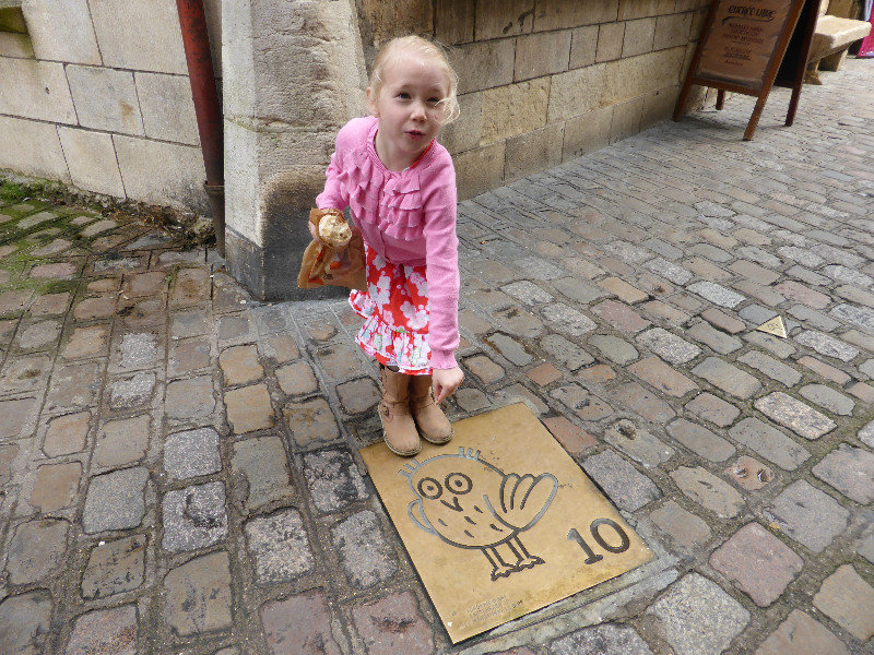 Gemma showing the owl marks in Dijon which guide tourists on a walking path to see the sites