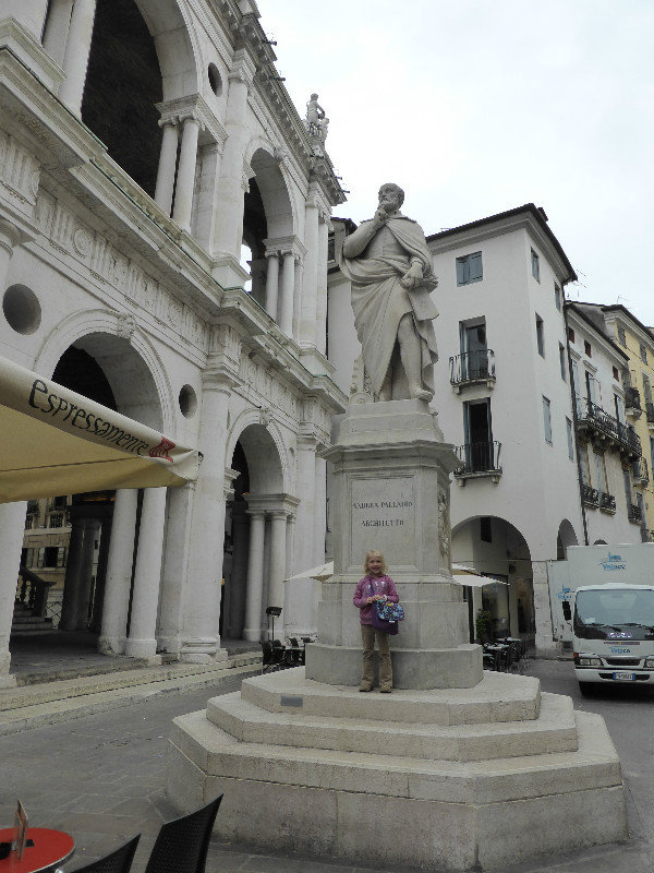 Gemma in front of a statue of Palladio who designed much of Vicenza in Italy