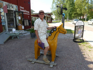 Tom sitting on Dla horse in Leksand in Dalarna Region Sweden