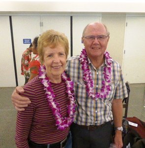 Honolulu Airport tired after flying through the night but happy now we have got our frangipani lei