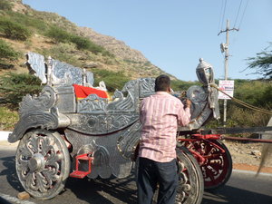 Wedding carriage with horses struggling to pull it up th hill