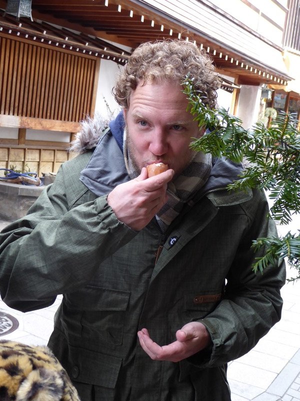 Eating boiled egg which was boiled in thermal spring in street in Yadanaka (1)