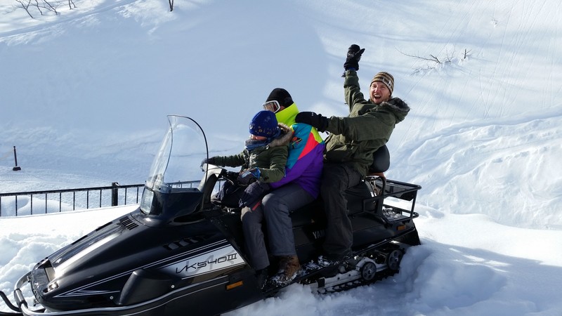 Adam, Tom & Gemma sitting on a snowmobile