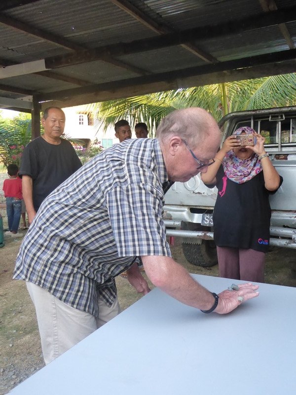 Home visit and games at a village near Sandakan - Tom playing knuckle bones