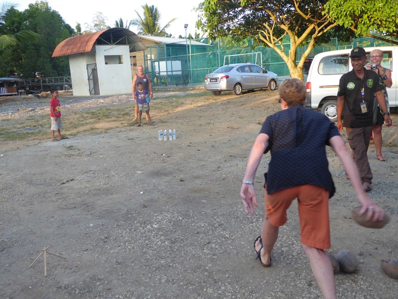 Home visit and games at a village near Sandakan = Pam playing skittles