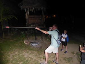 Tom using a blow-dart at Mari Mari Cultural Village