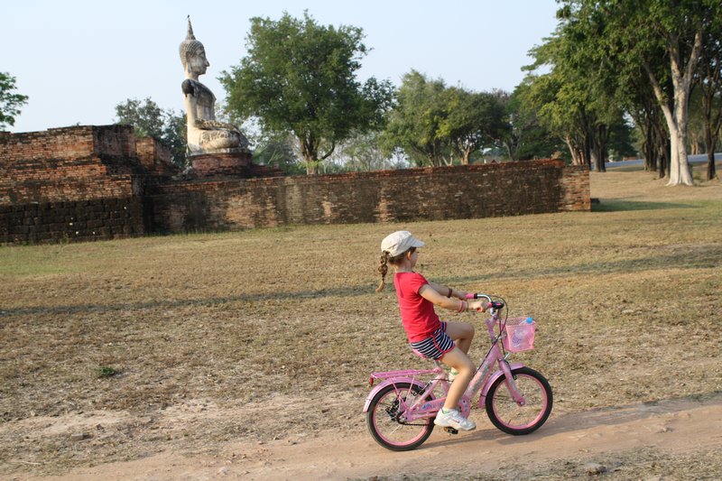 Cycling past a very old Buddha