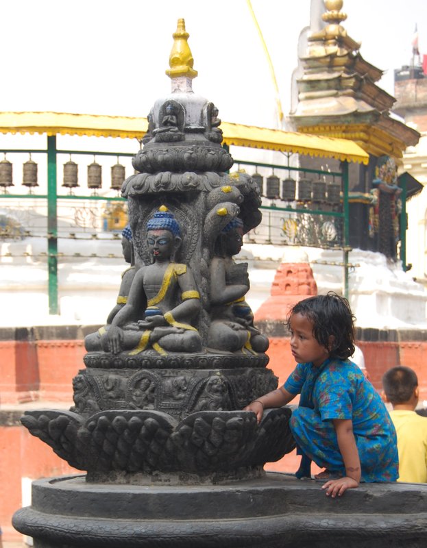 Little girl playing near a stupa