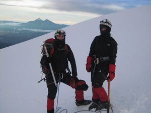 At the summit of Cotopaxi, the Illinizas in the background