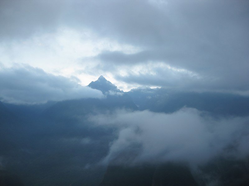 Early mists swirling around the mountains surrounding Machu Picchu