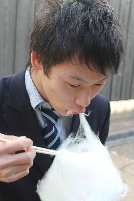 Eating 'suikerspin' (Cotton Candy) with chop sticks, Dejima, Nagasaki