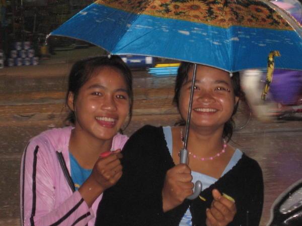 two Lao girls caught in the rain