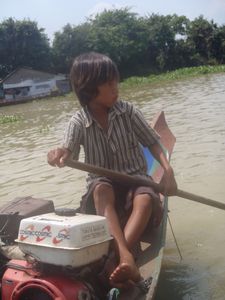 Cute little boy rowing out to our boat