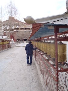 Prayer wheels which you walk by and spin before you enter each monastery.