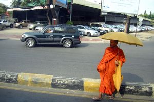 Monk crossing the street