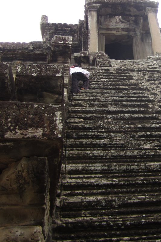 Man climbing Angkor Wat