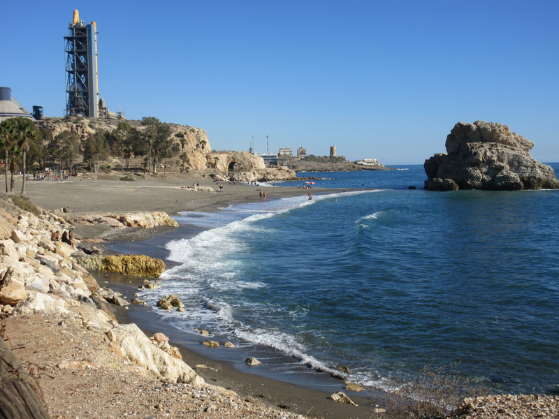 Beach near La Pena showing rock, tunnel, and cement factory