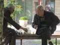 two men playing chess in the Park