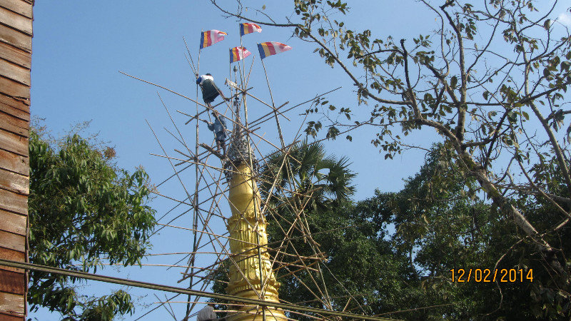 Repairing the Stupa on bamboo scaffolding