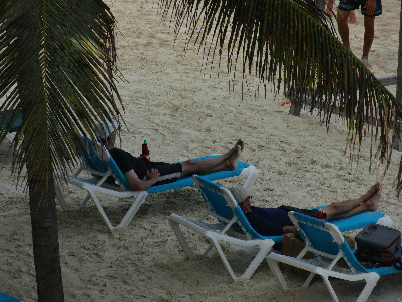dad & son on beach loungers