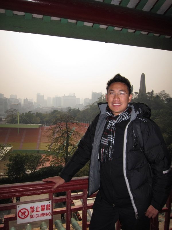 Peter with view on guangzhou in background on top of zhenhai tower