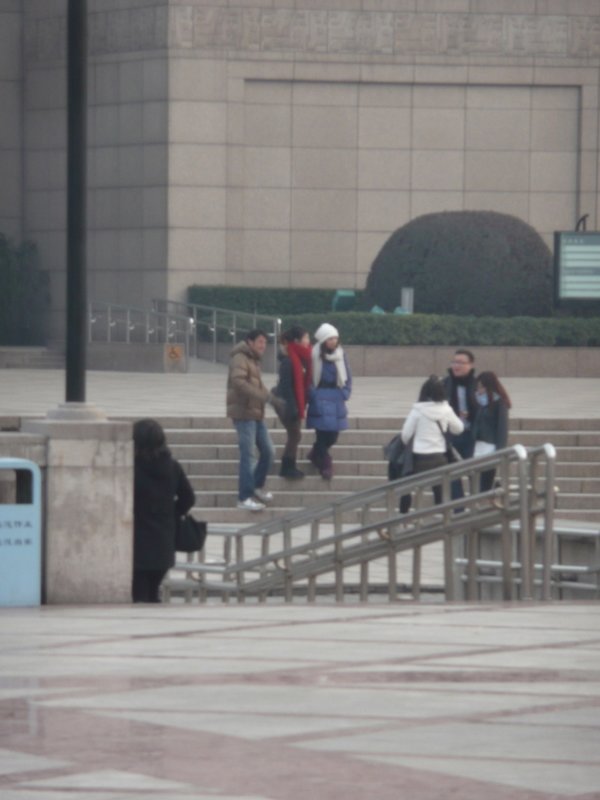Black op spy photo of scammers hanging around the exit of museum
