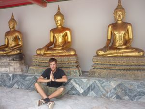 me praying in front of three buddhas Wat Pho Bangkok