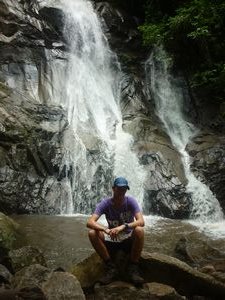 me sitting in front of a waterfall jungle Chiang Mai