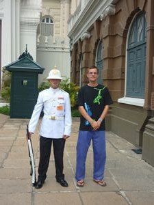 me standing net to a guard at Kings Palace Bangkok