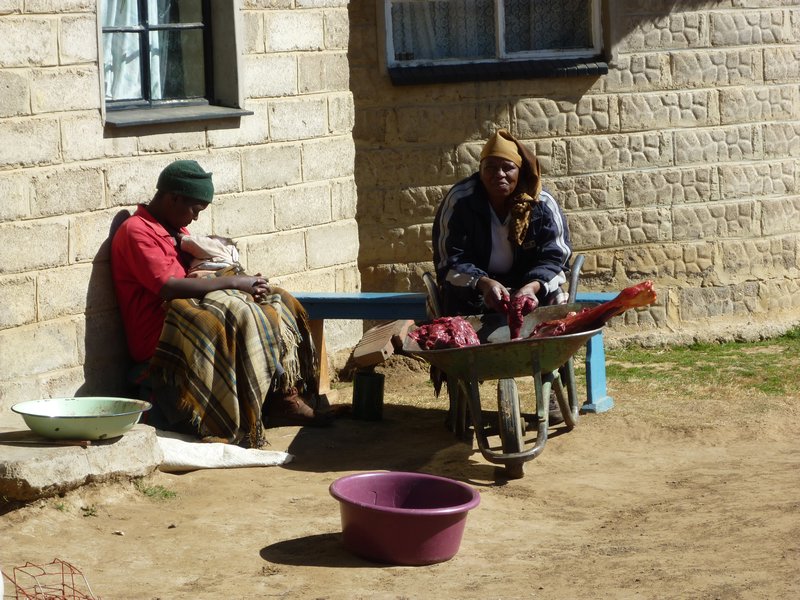 people in front of a house in Lesotho