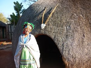 Zulu-woman in front of a hut in Valley of 1000 hills