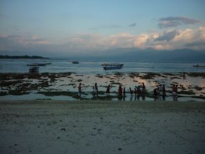 people, boats, coral at sunset Gili Trawangan