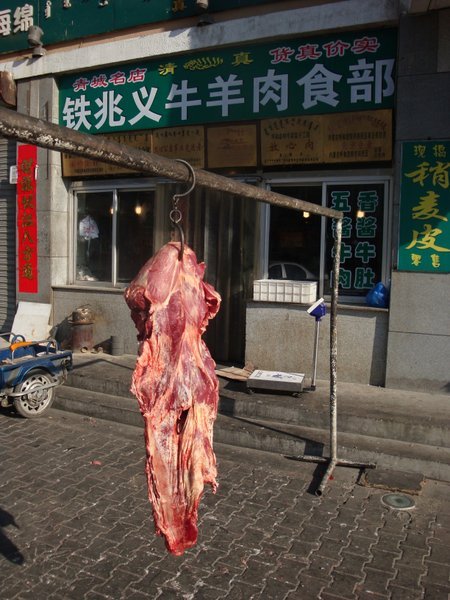 Meat hanging outside a butchers.