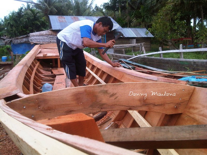 A craftman building a boat
