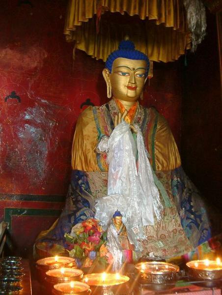 Statue with butter lamps