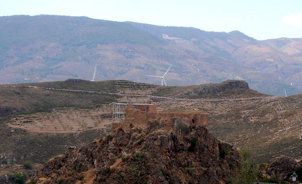 Lanjaron castle ruins with a wind farm behind