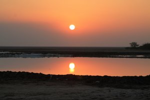 sunset over salt-extraction pond
