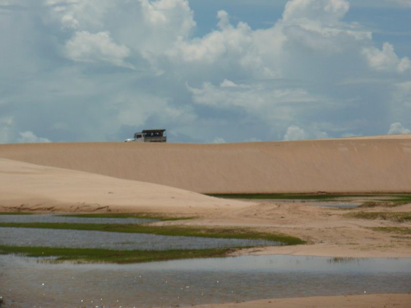 Another truck passing over the dune