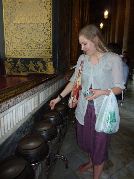 Suzi putting money in the monks bowls