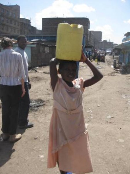 Young Mathare resident carries water home 