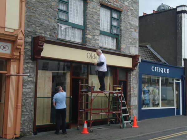 hand-painting a store sign in Killarney