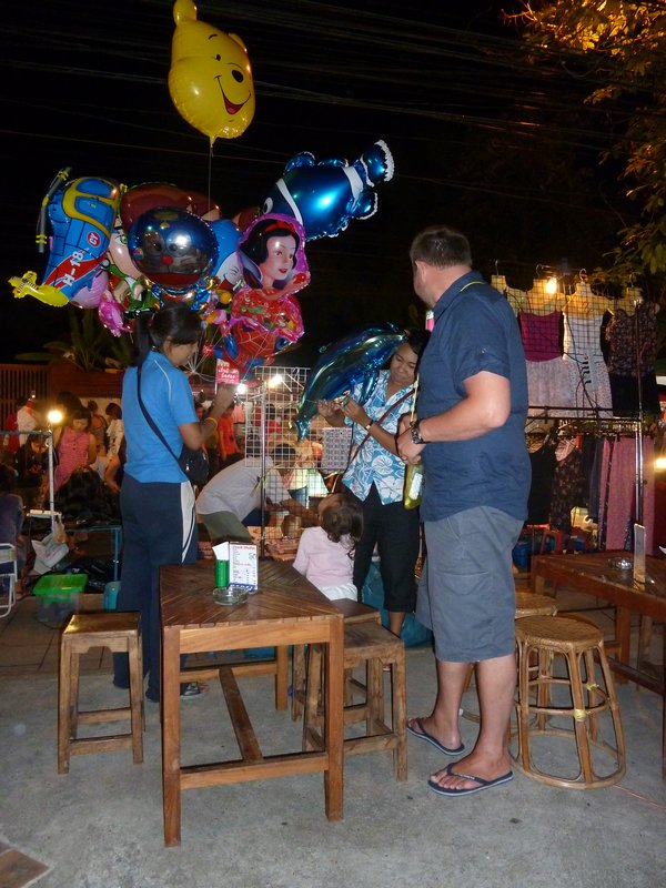 Joff buying a small child a baloon