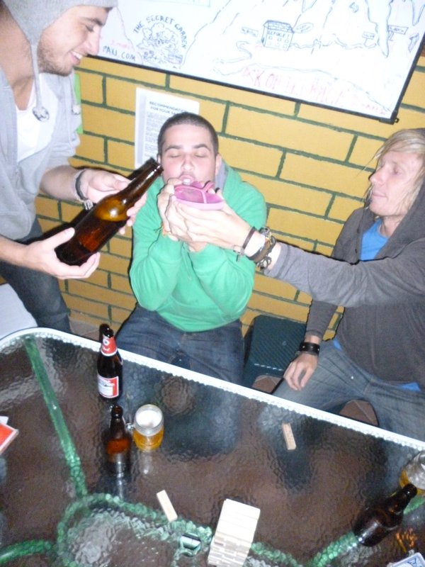 Chris drinks beer over a sandal as a result of jenga forfeit. Last Saturday night in Quito