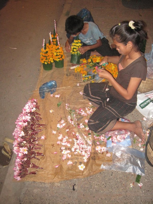 Local kids making flower offerings for Buddha in honor of the Mi Pai new year celebration