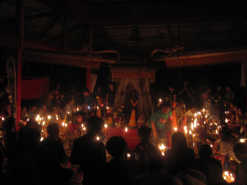 some sort of candelit buddhist ceremony...no flashes allowed, i imagine