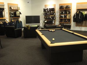 A BMW motorcycle dealership with a pool table!